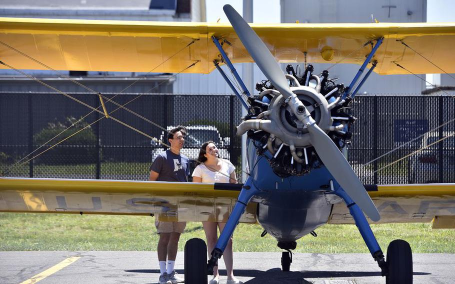 Andrew Estus and Cailin Fairbrother of South Kingston, R.I., check out a 1940s-era Stearman training plane.