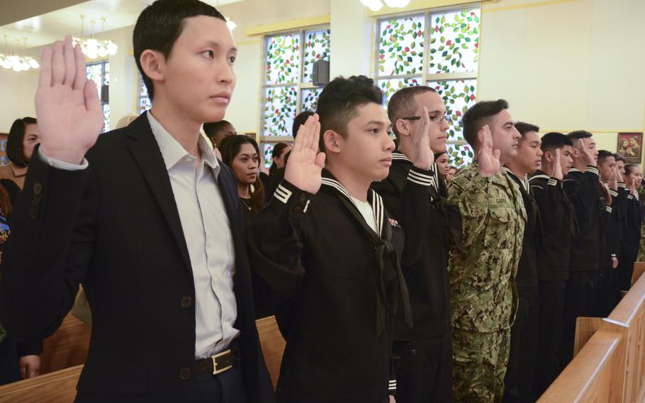 Thirty-six sailors and spouses from 13 different countries take the oath of allegiance during a naturalization ceremony at the U.S. Fleet Activities Yokosuka’s Main Chapel in 2018. 