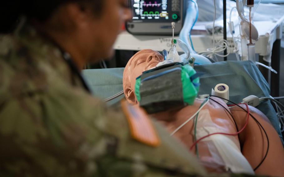 Army medics work with mannequins and live patients during a multi-day hospital exercise at Baumholder Army Airfield, Germany, in May 2024. Reserve soldiers who practiced life-saving techniques also built the temporary field hospital they worked in.