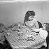 Aschaffenburg, Germany, Feb. 6, 1950: Betty Jo Fay, wife of First Sgt. Thomas H. Fay, of H Co. 18th Infantry, 1st Division, eats some soup and sandwiches with the couple's two children, Colleen, 5, and Richard, 3 at the family's kitchen table in their new apartment. The Fay family moved into one of the 156 newly constructed apartment units for servicemembers and their family in Aschaffenburg.

Read the accompanying article and see additional photos here. https://www.stripes.com/history/2022-06-13/eucom-housing-design-1950-6329852.html

META TAGS: history, european command, housing shortage post world war ii, military housing design, military housing europe, military housing