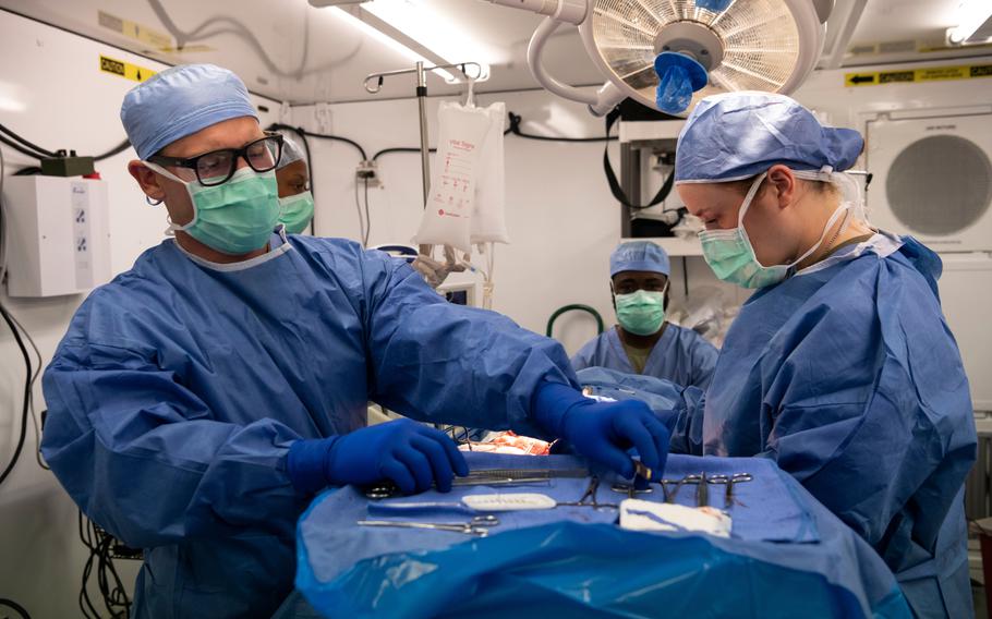 Army medics practice a surgical operation on a mannequin at a temporary field hospital at Baumholder Army Airfield, Germany, on May 17, 2024. Some 200 reserve soldiers deployed to Germany to build the hospital from Army pre-positioned stock, which had never been done in Europe before.