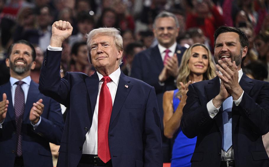Former President and 2024 Republican presidential candidate Donald Trump, left, gestures next to U.S. Senator from Ohio and 2024 Republican vice-president candidate J. D. Vance during the first day of the 2024 Republican National Convention at the Fiserv Forum in Milwaukee, on July 15, 2024. 