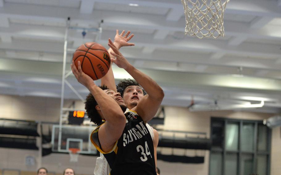 Stuttgart’s Trenton Jackson goes to the basket against Ramstein’s Jaden Guerra in the Division I championship game at the DODEA-Europe basketball championships in Ramstein, Germany, Feb. 18, 2023. Stuttgart took title with a 62-60 double overtime win.