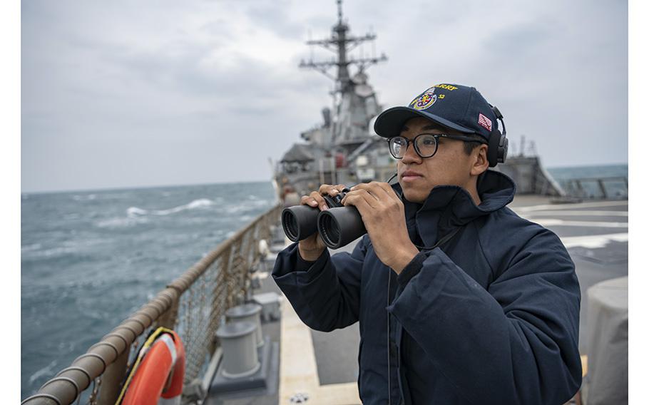 Seaman Xi Chan stands lookout on the flight deck of the Arleigh-Burke class guided missile destroyer USS Barry (DDG 52) during routine underway operations in the Taiwan Strait on April 23, 2020.