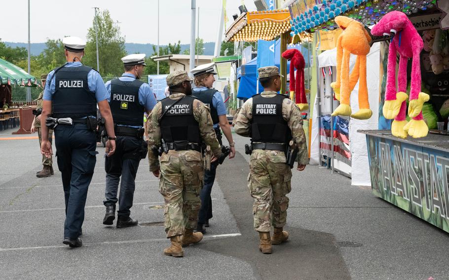 U.S. military police and German counterparts patrol the fairgrounds at the Hainerberg housing area in Wiesbaden, Germany, on June 29, 2023. The U.S. Army garrision in the city is inviting Germans to join in a festival celebrating Independence Day.