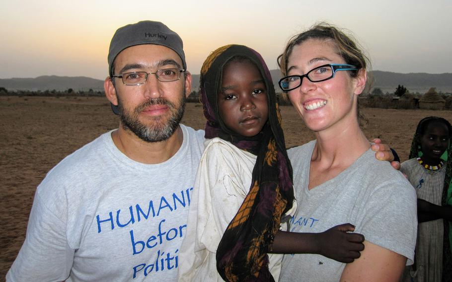 Gabriel Stauring, left, and Katie-Jay Scott, right, hold Darfuri refugee Guisma in Eastern Chad in 2009. 