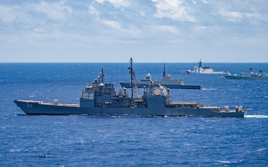 The guided-missile cruiser USS Lake Champlain (CG 57) participates in a group sail during an exercise off the coast of Hawaii in 2018.
