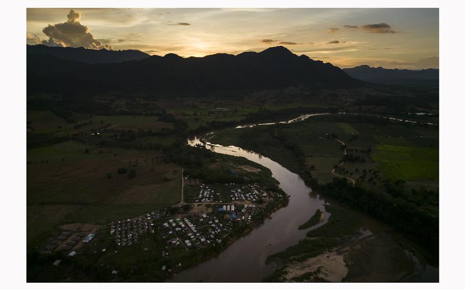 A lush mountain range of Karen-held territory in Kayin State, Myanmar, is seen across the Moei River, which runs along the Thailand-Myanmar border.