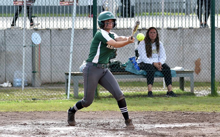 Naples senior Lucy Black connects with a pitch during the Division II/III DODEA European softball championship game against Rota on May 24, 2024, at Kaiserslautern High School in Kaiserslautern, Germany.