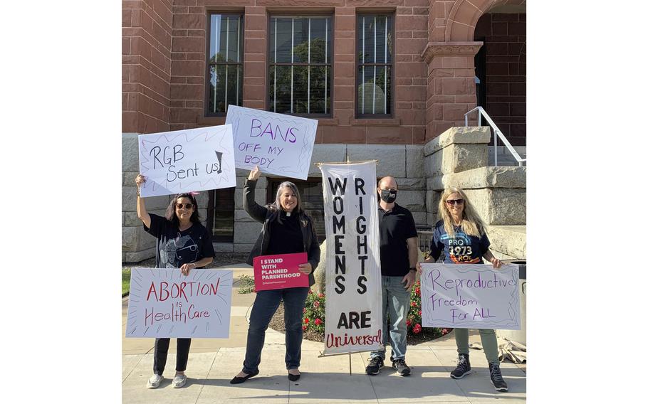In this photo provided by Felicity Figueroa, the Rev. Sarah Halverson-Cano, second from left, senior pastor of Irvine United Congregational Church in Irvine, Calif., leads congregants during a rally supporting abortion access, in Santa Ana, Calif., May 3, 2022.