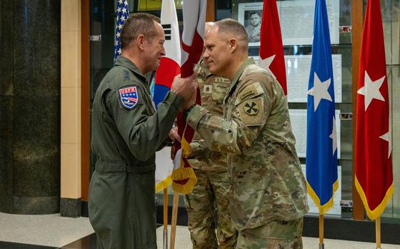 Lt. Gen. Christopher LaNeve, right, relinquishes the Eighth Army guidon to Lt. Gen. David Iverson at Camp Humphreys, South Korea, April 16, 2025.