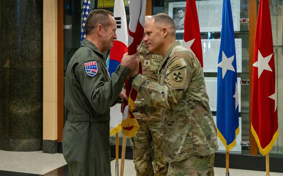 Lt. Gen. Christopher LaNeve passes the Eighth Army guidon to Lt. Gen. David Iverson.