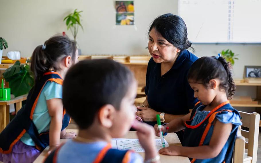 A woman speaks to the children she cares for at her home.