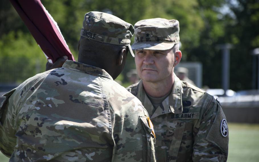 Brig. Gen. Clinton Murray accepts the Regional Health Command Europe flag from Lt. Gen. R. Scott Dingle, the surgeon general of the U.S. Army, in a ceremony in Landstuhl, Germany, June 1, 2022.