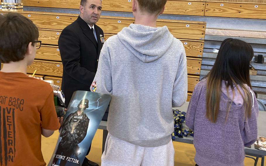 Students line up to speak with Chief Christopher Stevens, a Navy counselor, during Career Day at Yokota Air Base, Japan, Thursday, May 5, 2022.