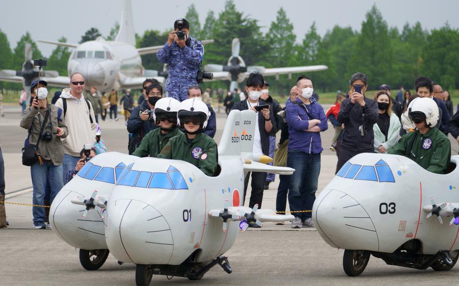 Members of the Japan Maritime Self-Defense Force ride modified mopeds during Spring Festival at Naval Air Facility Atsugi, Japan, April 22, 2023.