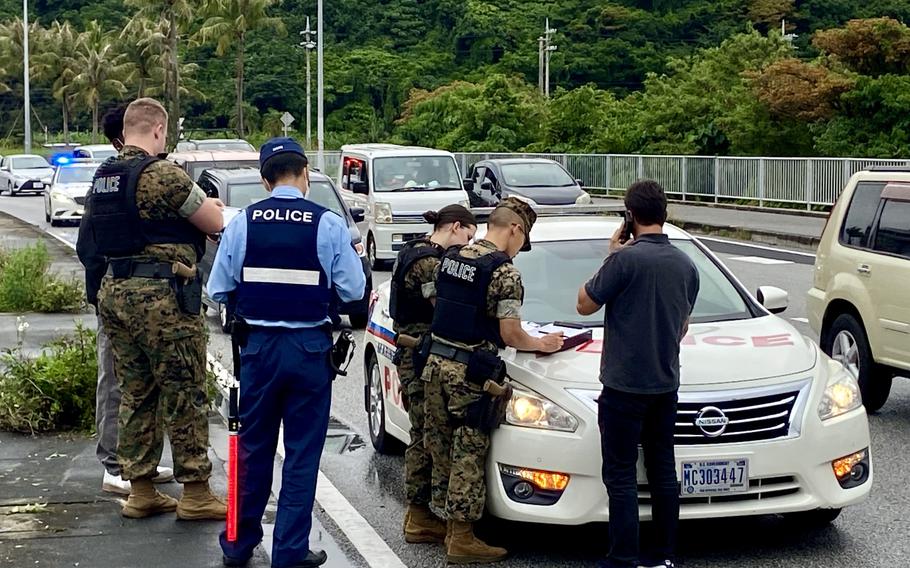U.S. military and Japanese police work a vehicle crash on Route 58 outside Camp Foster, Okinawa, Saturday, May 14, 2022.