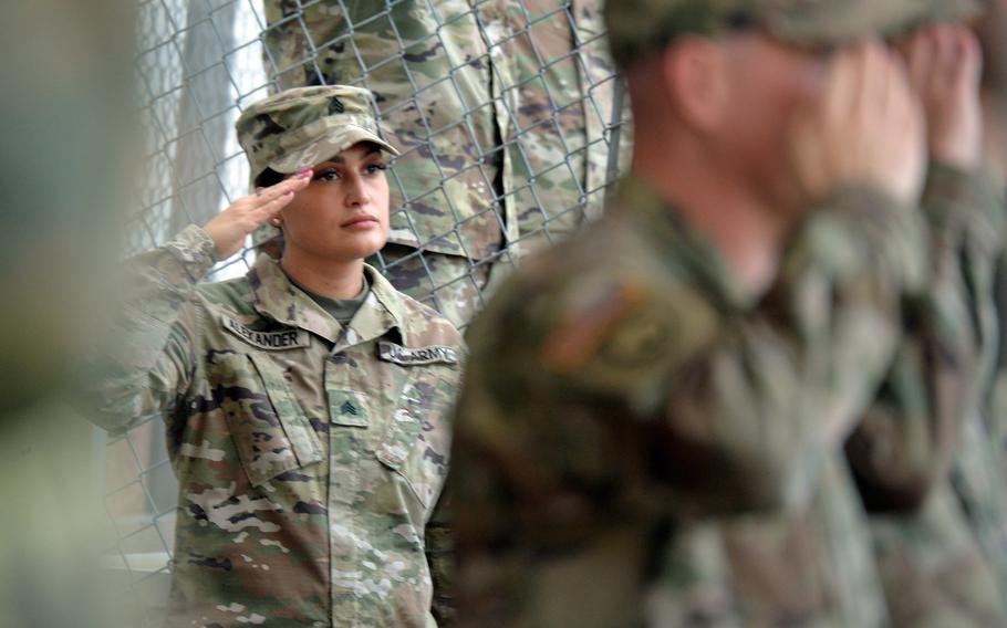 Soldiers listen to the national anthems of the United States and Germany during the 21st Theater Sustainment Command’s Veterans Day observance at Panzer Kaserne in Kaiserslautern, Germany, on Nov. 10, 2021.