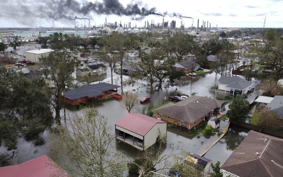 Homes near Norco, La., are surrounded by floodwater as chemical refineries continue to flare the day after Hurricane Ida hit southern Louisiana, Monday, Aug. 30, 2021. 