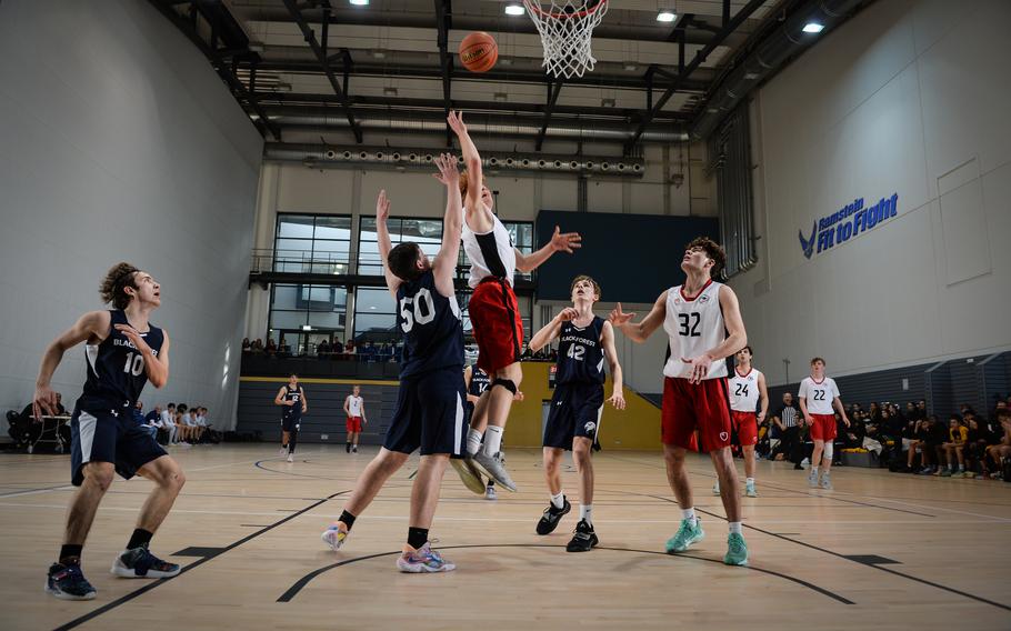 Anthony DiMatteo of the American Overseas School of Rome goes for a basket against Black Forest Academy, while Joey Ebenroth attempts to block his layup during the DODEA-Europe Division II boys basketball tournament Wednesday, Feb. 15, 2023, at Ramstein Air Base. AOSR won 53-41.