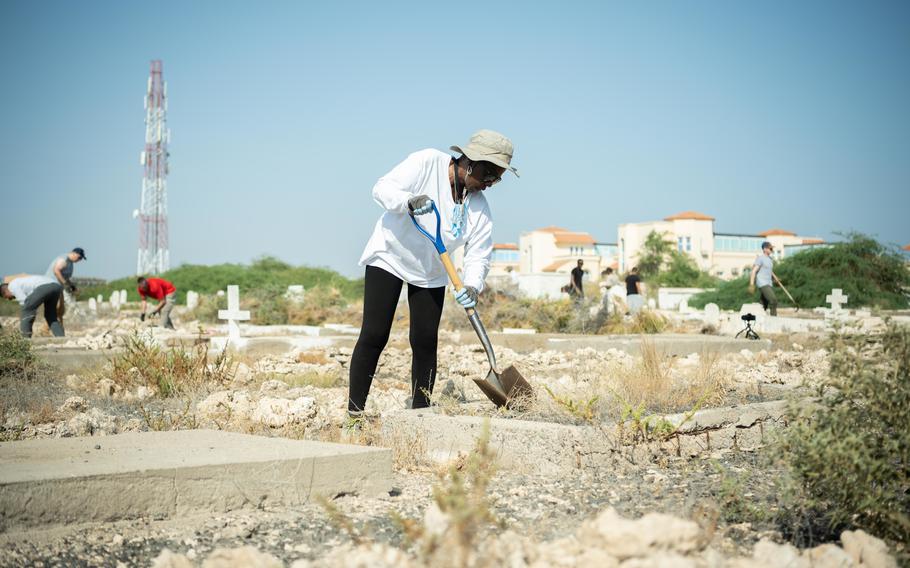 U.S. service members with the Combined Joint Task ForceHorn of Africa clean weeds and debris at the New European Cemetery in Djibouti city, Djibouti, Oct. 11, 2021. The cemetery is the final resting place for World War II veteran Arthur Lewis, who died in 1959 while at sea aboard the vessel S.S. Steel Vendor.