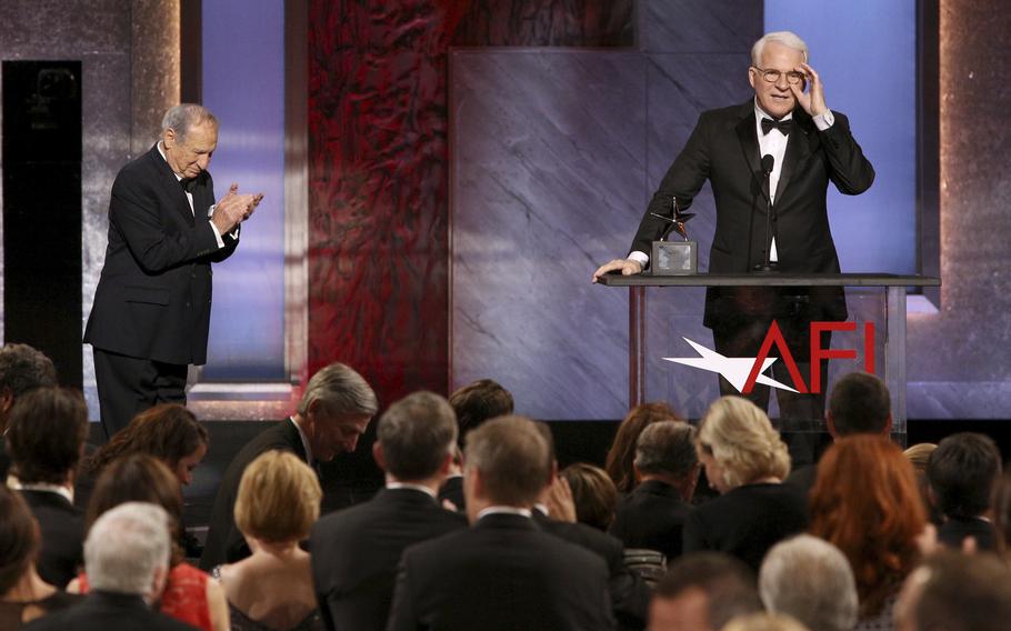 Steve Martin accepts his AFI Lifetime Achievement Award on June 4, 2015 at the Dolby Theatre in Los Angeles, as presenter Mel Brooks looks on at left. 