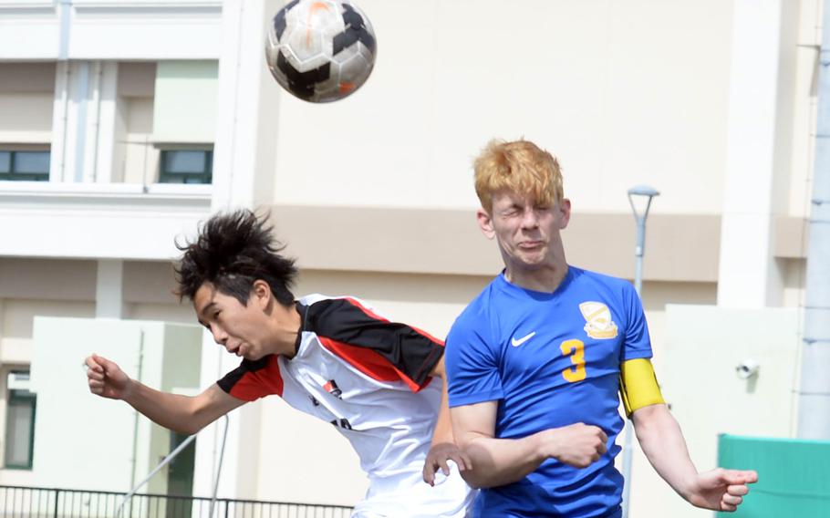 Nile C. Kinnick's Yuta Raqueno and Yokota's Caleb Jones go up to head the ball during the championship match in the Perry Cup soccer tournament. The Red Devils shut out the Panthers 2-0.