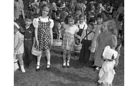 Frankfurt, Germany, April 17, 1949: A little girl looks triumphant holding not one, but two easter baskets filled with eggs and a chocolate bunny as her friends around her look less pleased. The dependent and local children scoured the grounds of the Palmgarten, Frankfurt’s botanical Palm Garden, at the Easter Sunday Egg Hunt,  sponsored by the local Allied Women’s Club. Baskets, bags, and boxes in hand they ran around trying to find most of them to take home one of the prizes for the most eggs found. The traditional Easter Egg Hunt was sponsored by the local Allied Women’s Club. 

Looking for Stars and Stripes’ historic coverage? Subscribe to Stars and Stripes’ historic newspaper archive! We have digitized our 1948-1999 European and Pacific editions, as well as several of our WWII editions and made them available online through https://starsandstripes.newspaperarchive.com/

META TAGS:  Easter; holiday; military family; military life; children; Easter Egg hunt; Botanical garden; Christian holiday; Allied Women's Club of Frankfurt