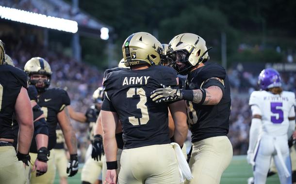 Football players in the black and gold West Point athletics uniform.