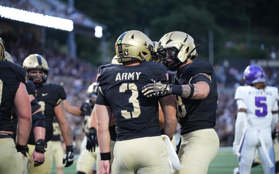 Football players in the black and gold West Point athletics uniform.
