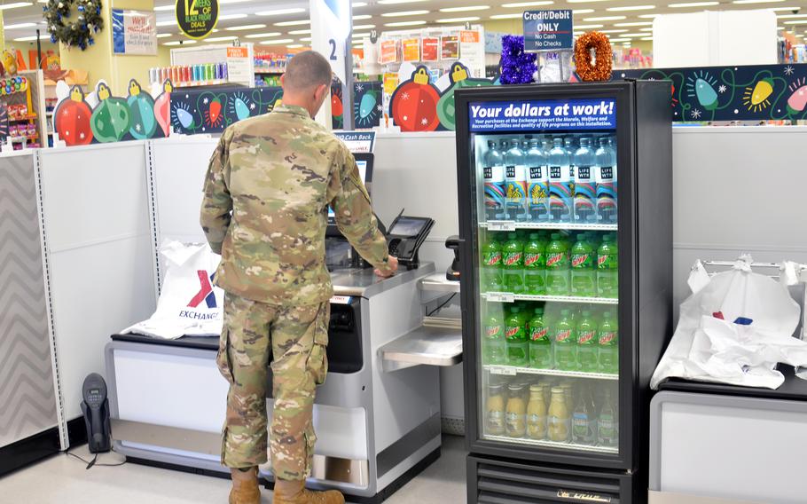 An airman uses a new self-checkout station inside the exchange at Yokota Air Base, Japan, Thursday, Oct. 27, 2022.