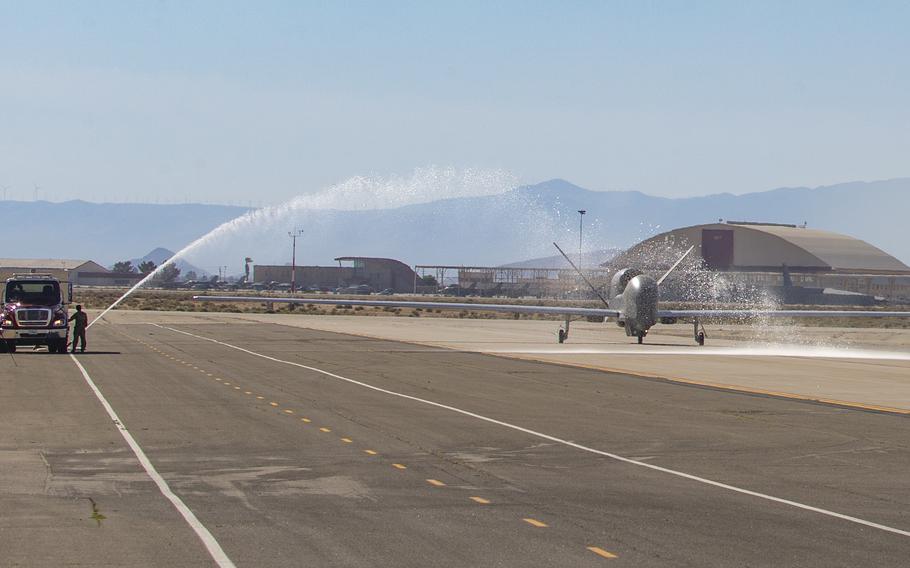 Fire trucks from the 812th Civil Engineer Squadron provide a water salute to an RQ-4 Global Hawk, assigned to and operated by the 452nd Flight Test Squadron, May 23, 2023, at Edwards Air Force Base in California. The 452nd FLTS marked the completion of the aircraft’s flight test program June 9, 2023.