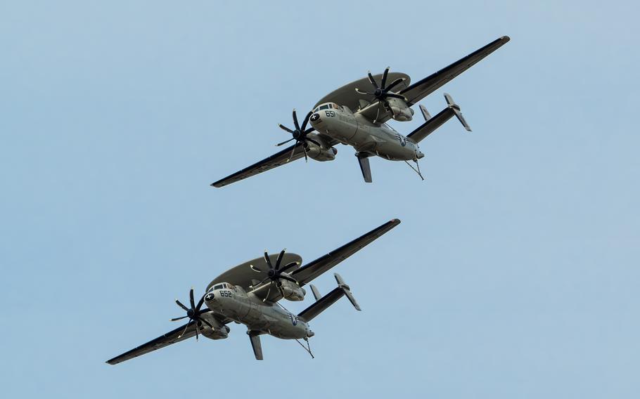 Two U.S. Navy E-2C Hawkeyes from Norfolk Naval Air Station, Va., perform an aerobatic display during the Thunder Over Louisville air show in Louisville, Ky., Saturday, April 20, 2024.