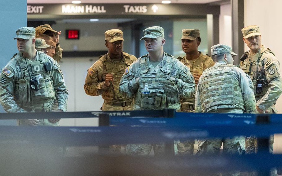 A group of National Guard soldiers in a train station.
