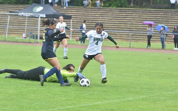 Ansbach goalkeeper Kennedy Lange grabs onto the ball just before AFNORTH's Selah Skariah can kick it, while Abigail Castillo tries to help Tuesday, May 21, 2024, at the DODEA European Division III girls soccer championships at Landstuhl, Germany.