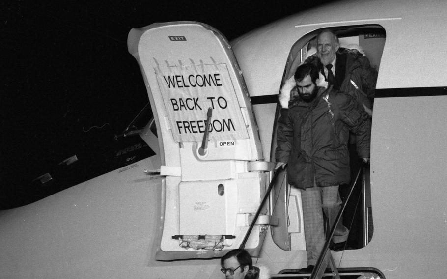 Hostages emerge to cheers as they step out of one of the two C-9 planes that ferried them from Tehran, Iran, to Rhein-Main Air Base in Germany.