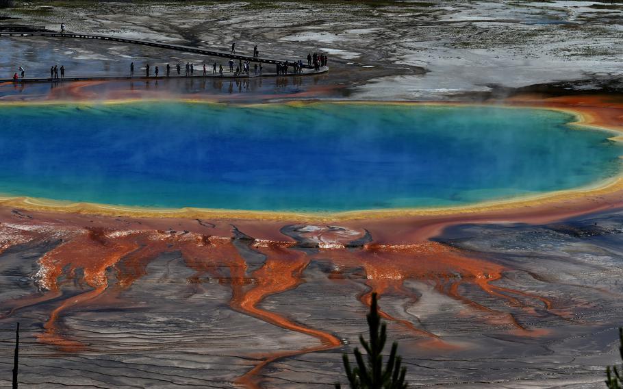 Tourists line the boardwalk of the Grand Prismatic hot spring, which was created by the Yellowstone supervolcano. 