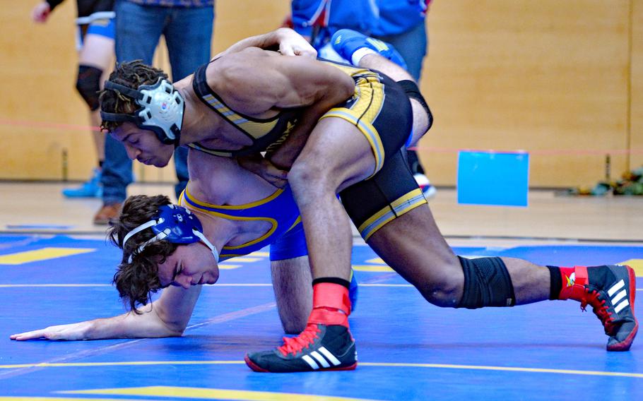 Stuttgart’s Josiah Doughty, top, tries to drive Sigonella’s John Berry to the mat in a first round, 150-pound match at the DODEA-Europe wrestling finals in Wiesbaden, Germany, Feb. 10, 2023. 