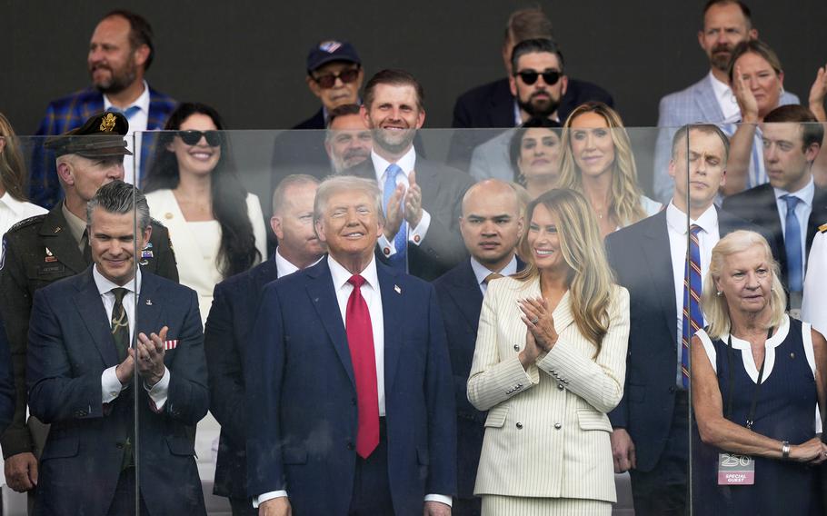 President Donald Trump, first lady Melania Trump, and Defense Secretary Pete Hegseth, left, attend a military parade.