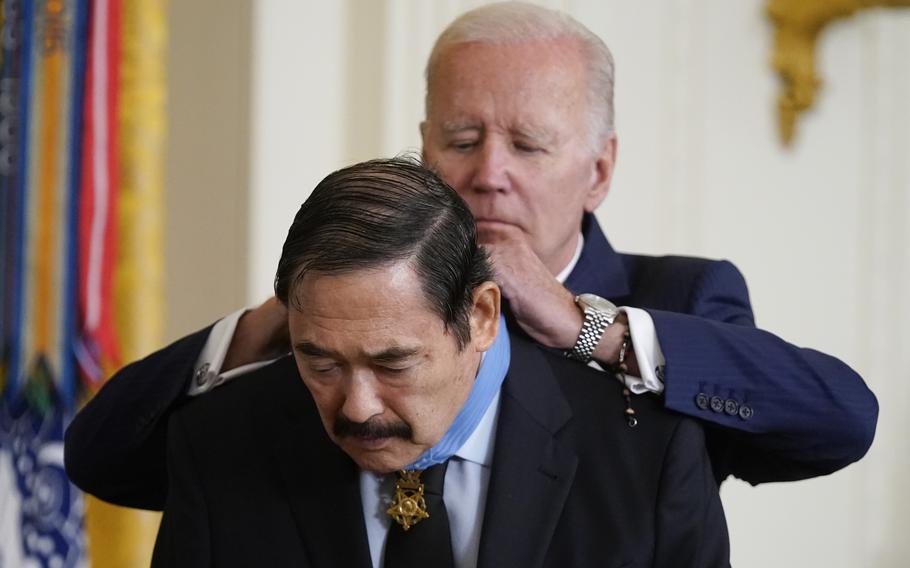 President Joe Biden awards the Medal of Honor to Spc. Dennis Fujii for his actions on Feb. 18-22 1971, during the Vietnam War, during a ceremony in the East Room of the White House, Tuesday, July 5, 2022, in Washington. 