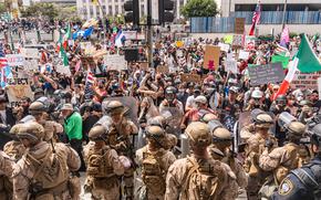 Troops standing in front of protesters.