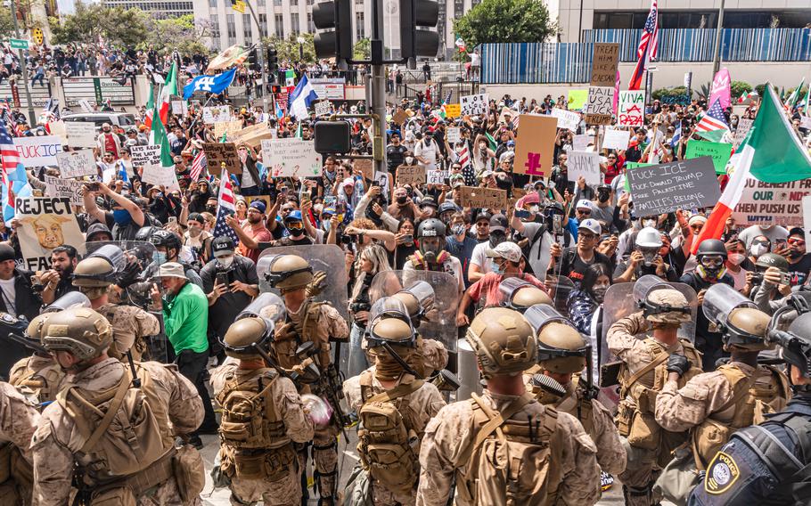 Troops standing in front of protesters.