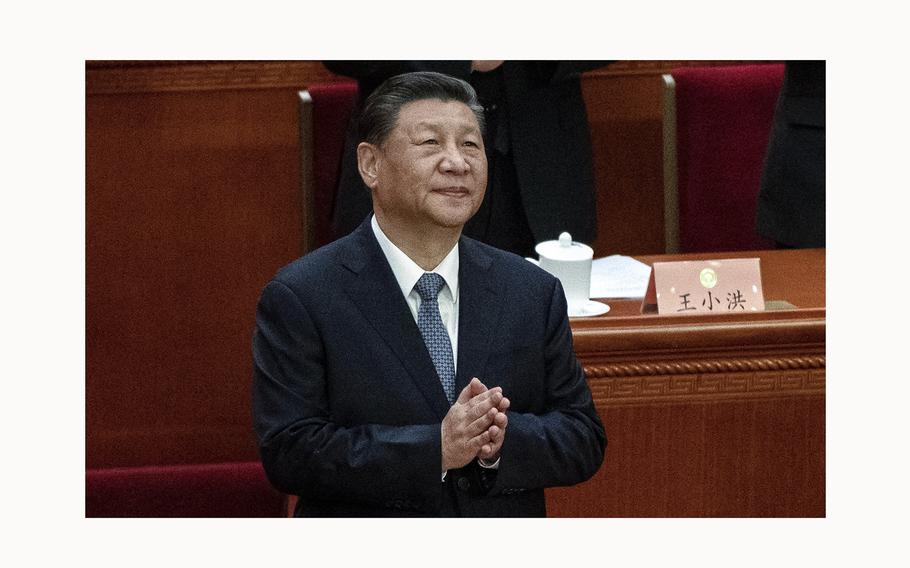 Chinese President Xi Jinping clasps his hands as he stands at the opening session of the CPPCC, or Chinese Peoples Political Consultative Conference, at the Great Hall of the People on March 4, 2024, in Beijing. 