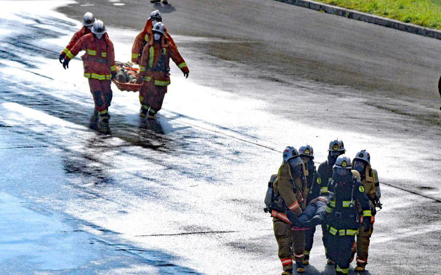 Marine Corps and Japanese first responders train to a handle a military helicopter crash at Camp Hansen, Okinawa, Thursday, Feb. 9, 2023.