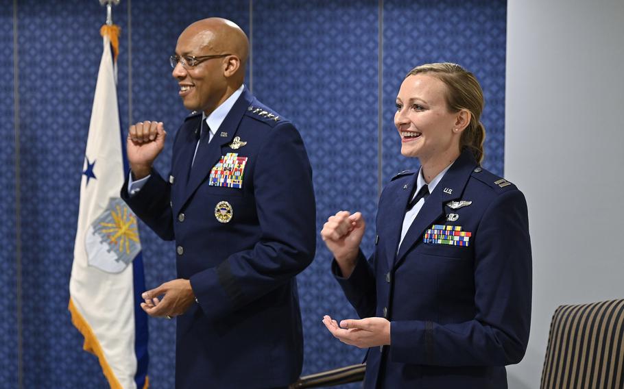 Capt. Taylor Bye and Air Force Chief of Staff Gen. CQ Brown Jr. sing the Air Force song during a ceremony at the Pentagon, Arlington, Va., May 11, 2022. Bye was awarded the 2020 Koren Kolligian Jr. Trophy to recognize her outstanding airmanship when her A-10C attack aircraft suffered a catastrophic gun malfunction and she performed a belly landing with the loss of the landing gear and canopy.