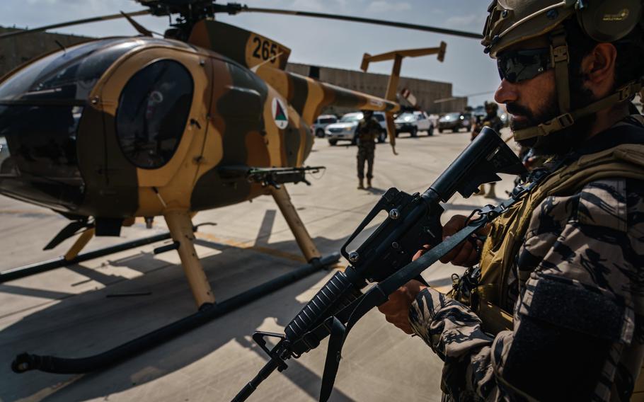 Taliban fighters stand ready as the militant group secure the Hamid Karzai International Airport, in the wake of the American forces completing their withdrawal from the country in Kabul, Afghanistan, Tuesday, Aug. 31, 2021. 