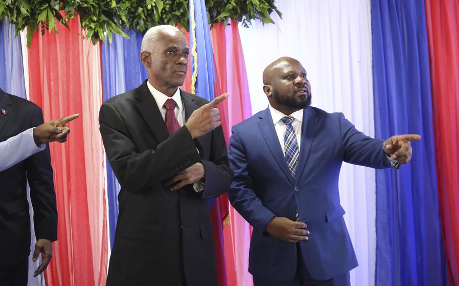 Edgard Leblanc Fils, left, and Smith Augustin prepare to pose for a group photo with the transitional council after it named Fils as its president in Port-au-Prince, Haiti, Tuesday, April 30, 2024. 