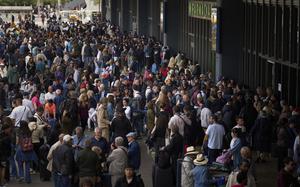 People wait outside a closed train station, during a  major power outage in Barcelona, Spain, Monday, April 28, 2025. (AP Photo/Emilio Morenatti)