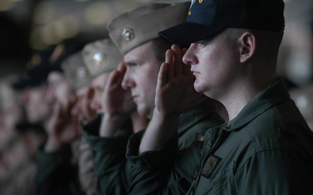 Aboard the USS Kitty Hawk, Apr. 10, 2003: Sailors salute during a memorial service for a former Carrier Air Wing 5 member Thursday on the USS Kitty Hawk.

META TAGS: Wars on Terror; U.S. Navy; USS Kitty Hawk; memorial; 