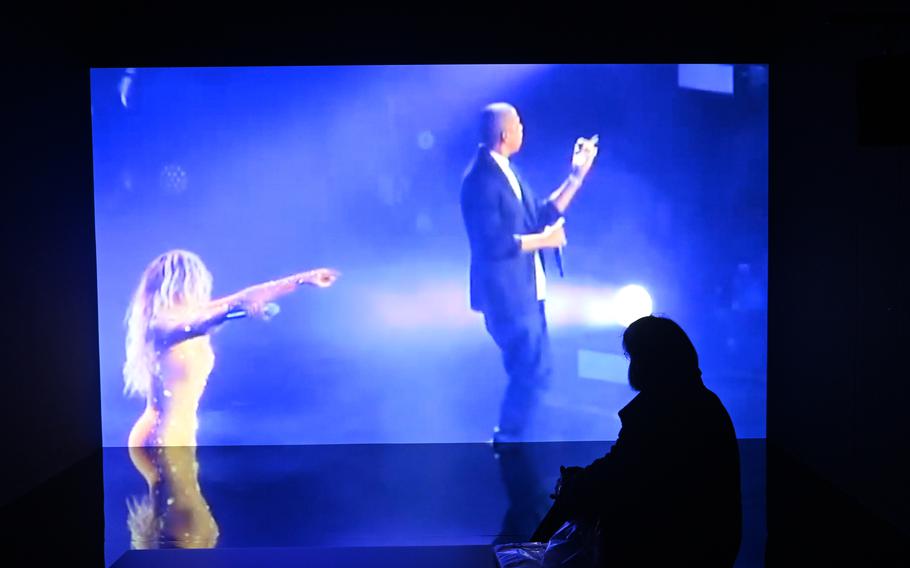 A visitor to “The Culture: Hip Hop and Contemporary Art in the 21st Century” show at the Schirn in Frankfurt, Germany, watches the video installation “4:44” by TNEG that features Beyonce and Jay-Z serenading each other.